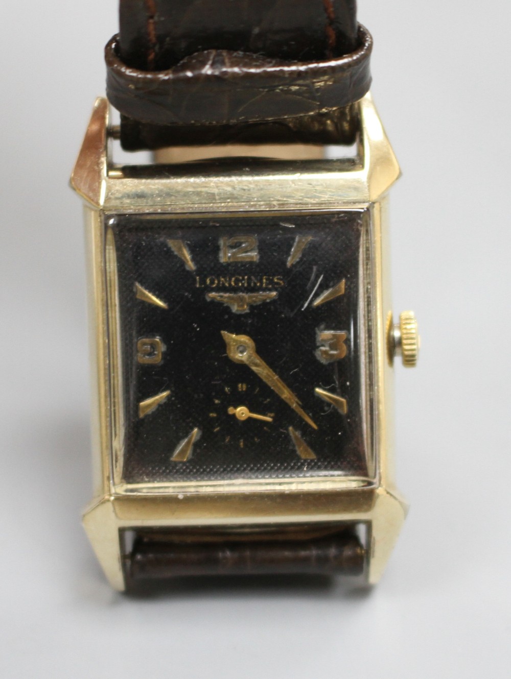 A gentlemans 1940s 10k gold filled Longines manual wind wrist watch, with rectangular Arabic and baton dial